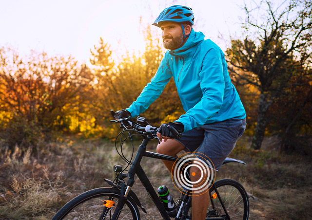 Active man cycling after custom knee replacement surgery